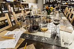 A small picture of a wine tasting table with bottles of wine